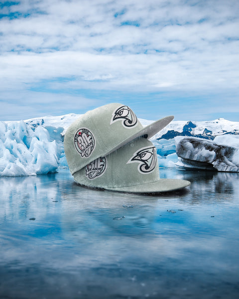 NEW ERA 5950 GLACIER COLLECTION HERO IMAGE-TORONTO BLUE JAYS ICE GREEN IN COLOR IN ARTIC SETTING